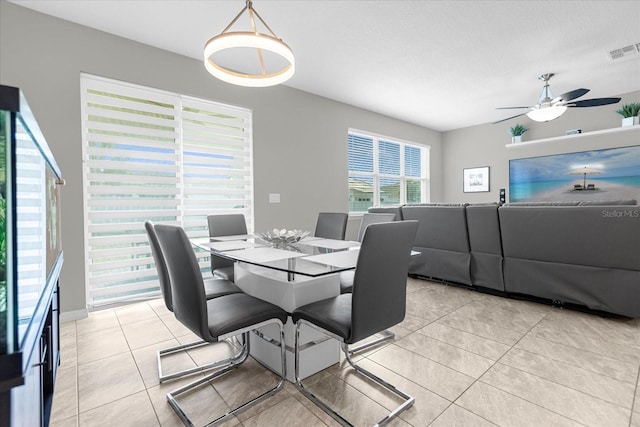 tiled dining area featuring ceiling fan