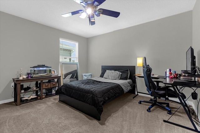 bedroom with light carpet, ceiling fan, and a textured ceiling