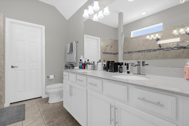 bathroom with toilet, tile floors, vaulted ceiling, and dual vanity