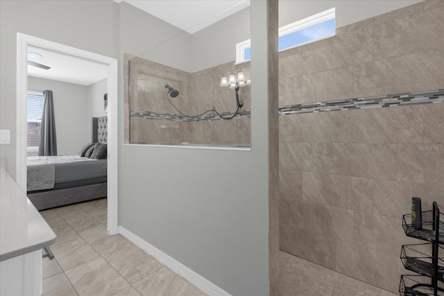 bathroom with tile flooring, an inviting chandelier, and tiled shower