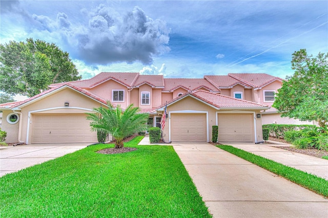 mediterranean / spanish-style home with a garage and a front yard