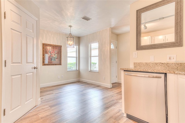 interior space with rail lighting and light hardwood / wood-style floors