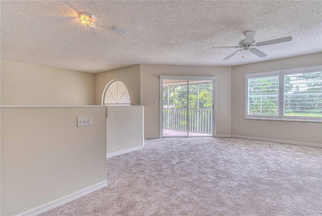 unfurnished room with carpet floors, a textured ceiling, and ceiling fan