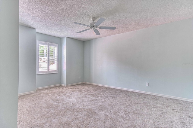 carpeted spare room featuring a textured ceiling and ceiling fan