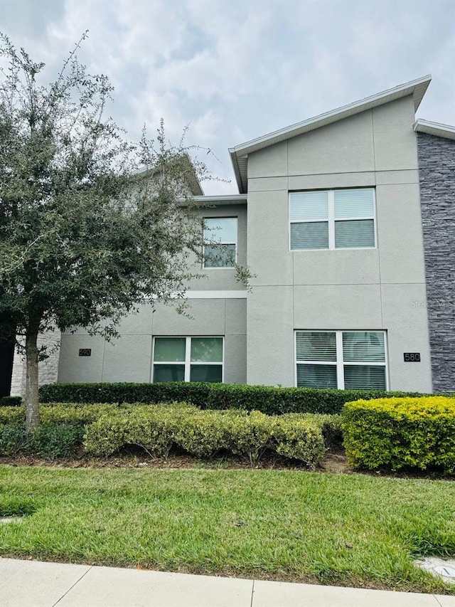 view of side of property with a yard