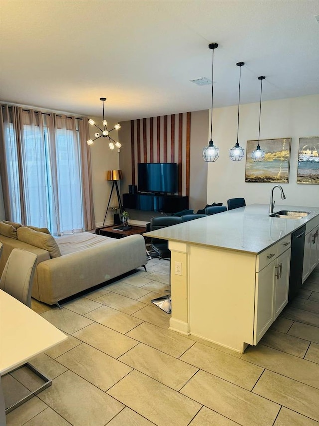 kitchen with a chandelier, light tile floors, black dishwasher, hanging light fixtures, and light stone counters