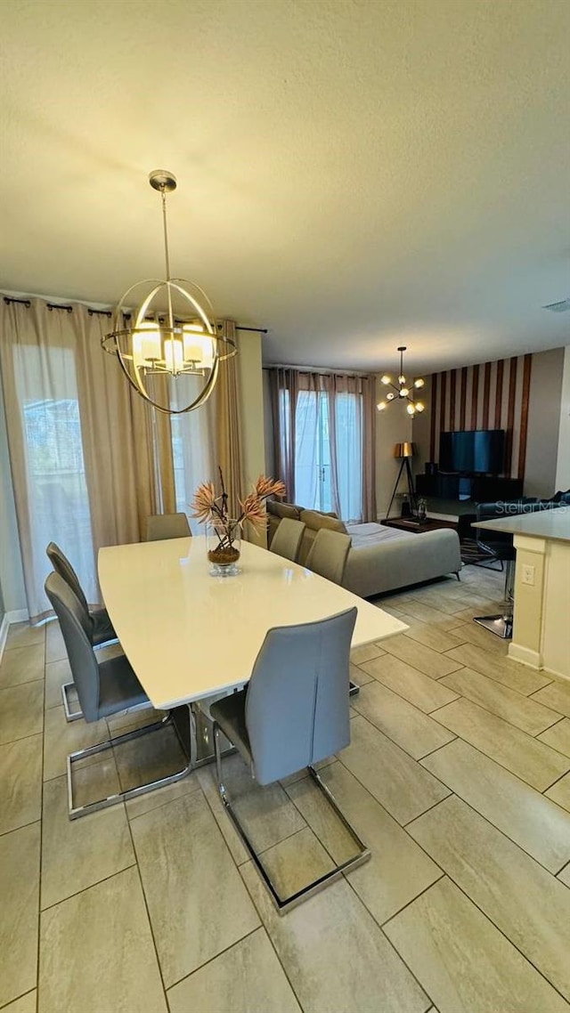 dining space featuring a chandelier and light tile flooring