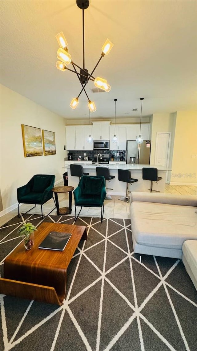 living room featuring a notable chandelier and tile flooring