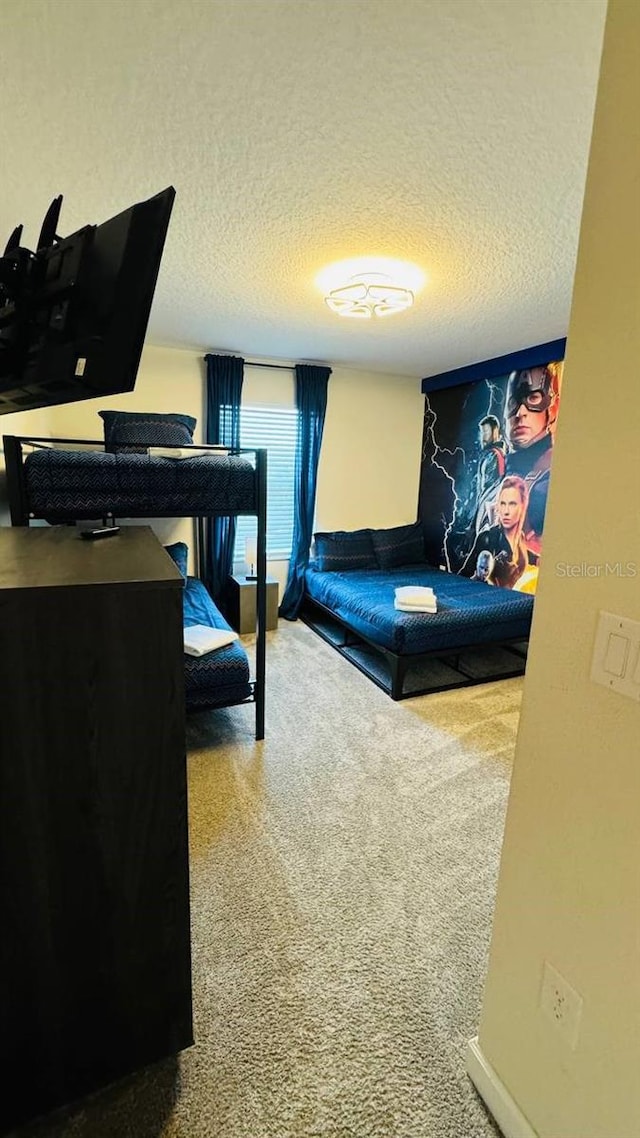 bedroom featuring carpet flooring and a textured ceiling