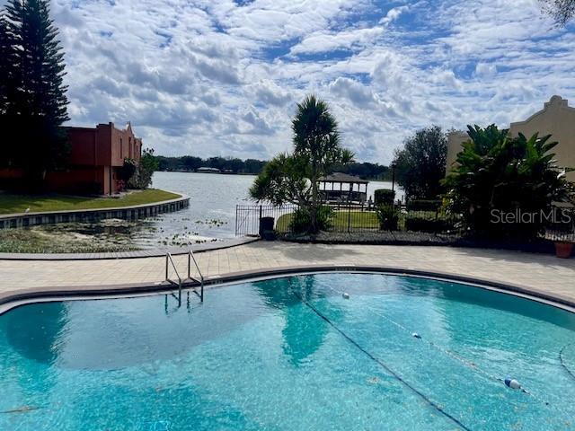 view of pool with a water view