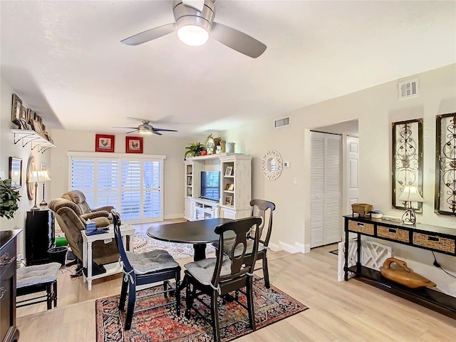 dining area featuring light hardwood / wood-style floors and ceiling fan