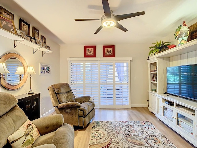 living area with ceiling fan and light hardwood / wood-style floors