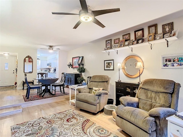 living room featuring ceiling fan and light wood-type flooring