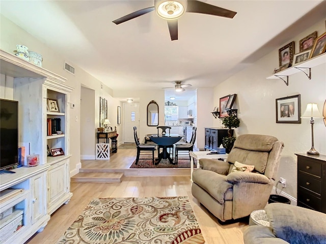 living room with ceiling fan and light hardwood / wood-style floors