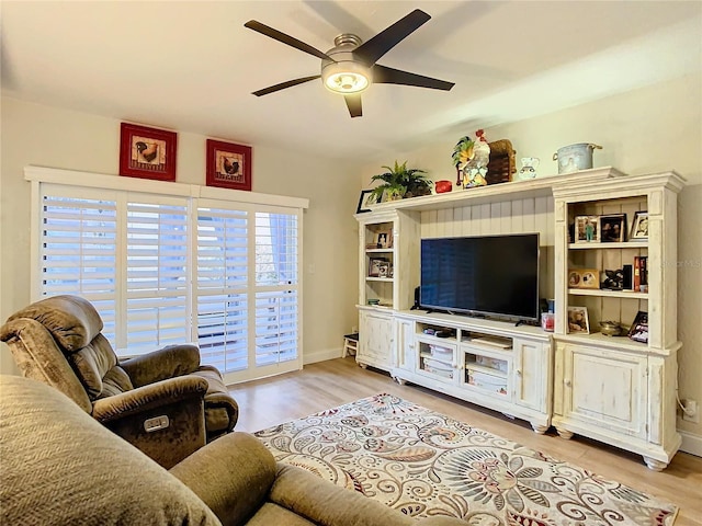 living room with ceiling fan and light wood-type flooring