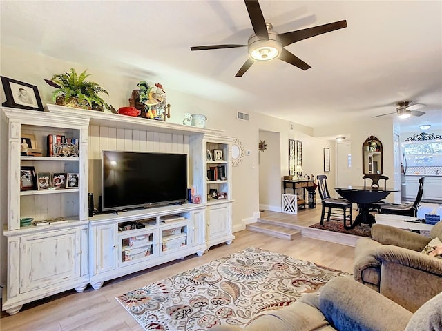 living room with ceiling fan and light hardwood / wood-style flooring