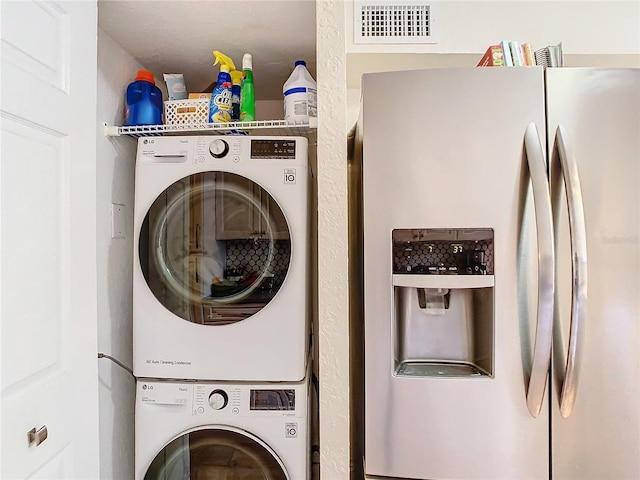 laundry room featuring stacked washer / dryer