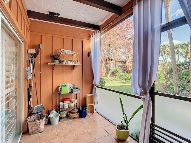 sunroom featuring beamed ceiling