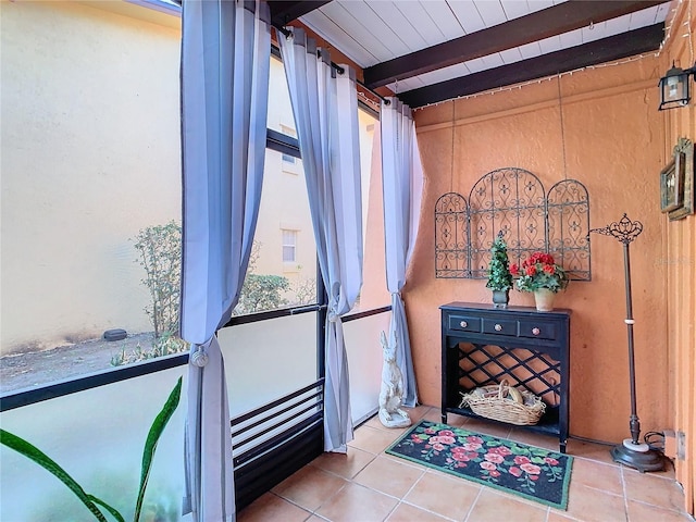 interior space featuring beam ceiling and tile patterned flooring