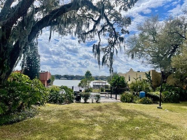 view of home's community featuring a water view and a yard