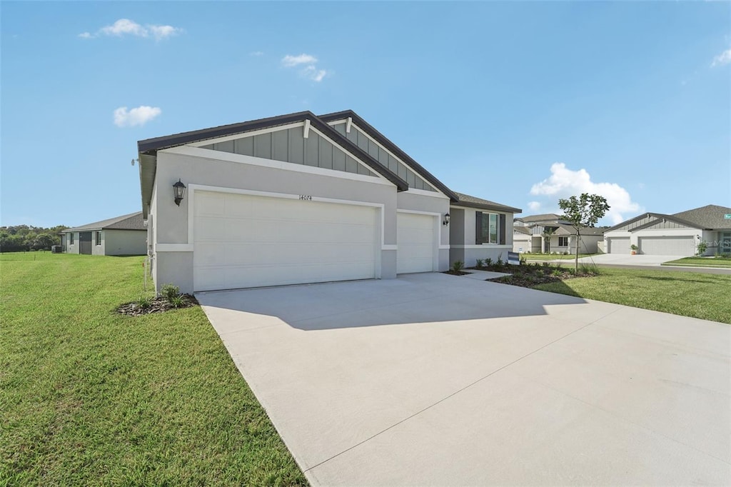 ranch-style home with a front yard and a garage