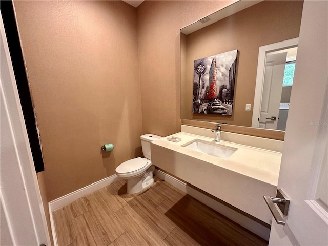 bathroom featuring toilet and vanity