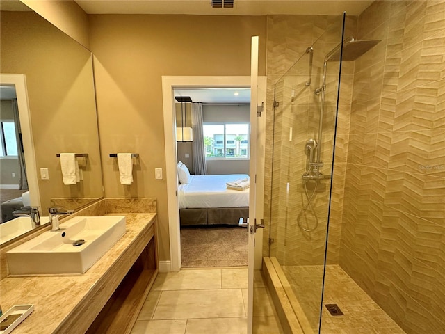 bathroom featuring vanity, a shower with door, and tile flooring