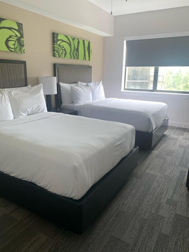 bedroom featuring dark colored carpet