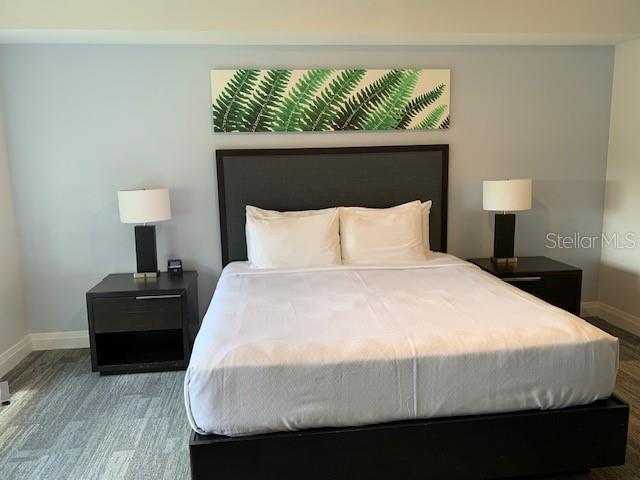 bedroom featuring carpet flooring and baseboards