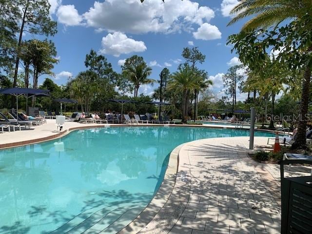 community pool featuring a patio area