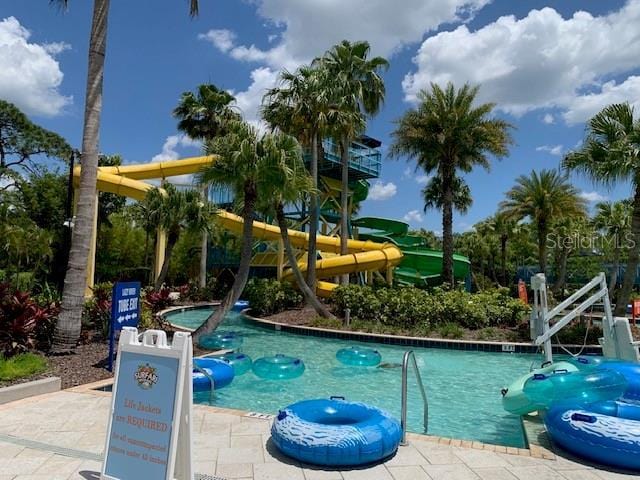 community pool featuring a water slide