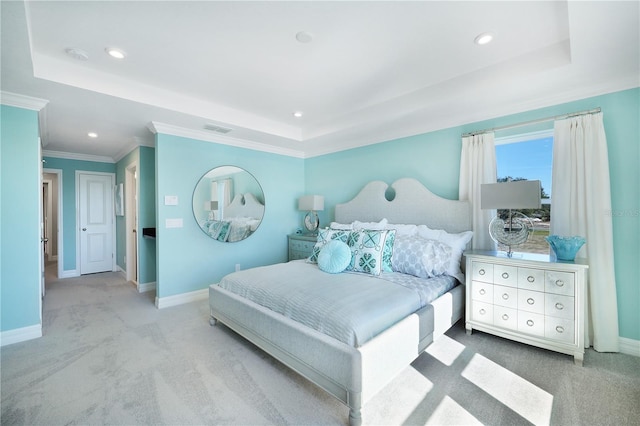 bedroom featuring crown molding, a tray ceiling, and light colored carpet