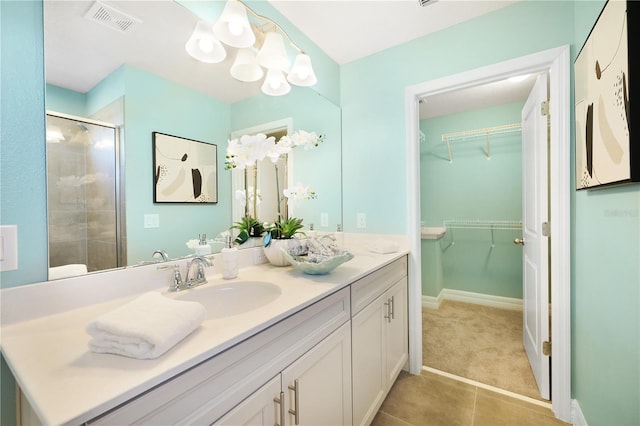 bathroom featuring walk in shower, tile floors, and vanity