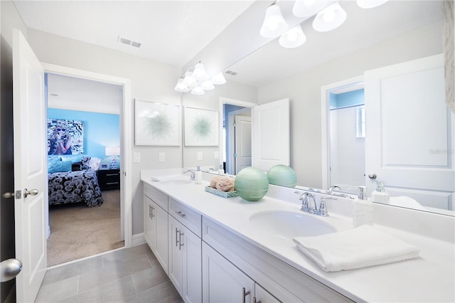 bathroom featuring tile flooring, dual sinks, and vanity with extensive cabinet space