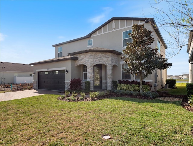 view of front of property featuring a front lawn and a garage