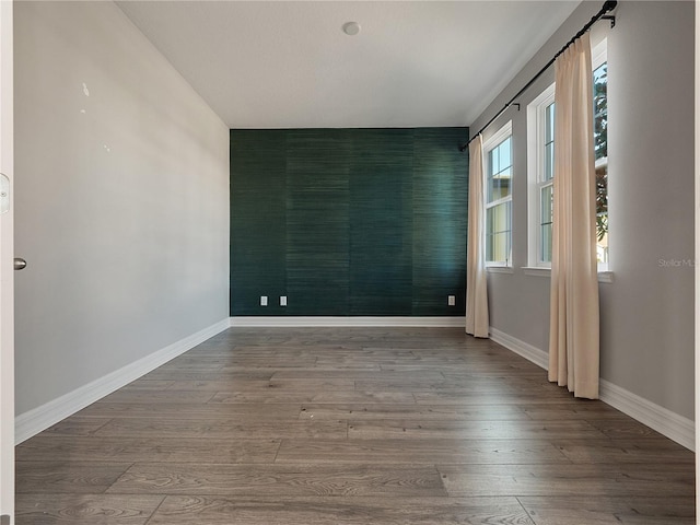 unfurnished room featuring dark wood-type flooring