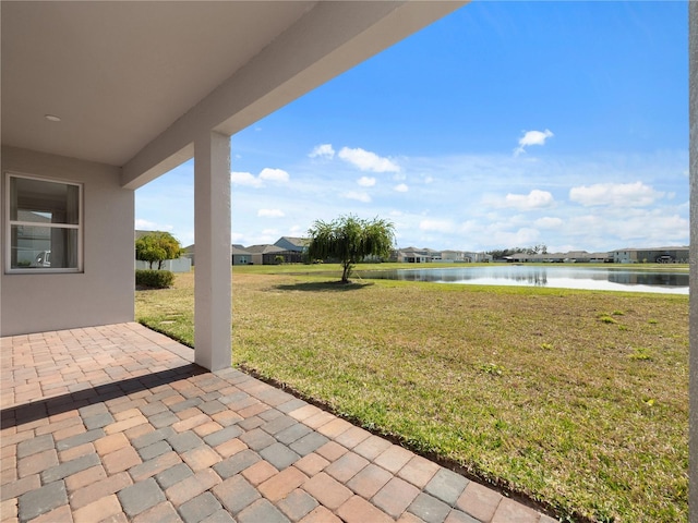 view of yard with a patio and a water view