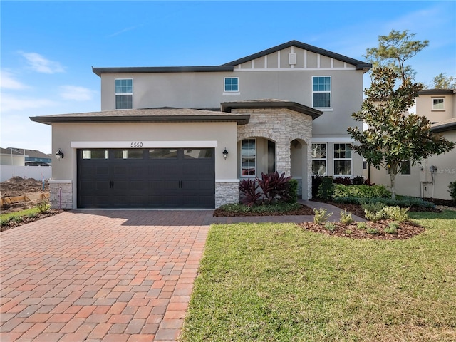 view of front of home with a front yard and a garage