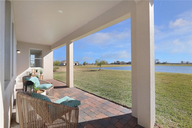 view of terrace with a water view