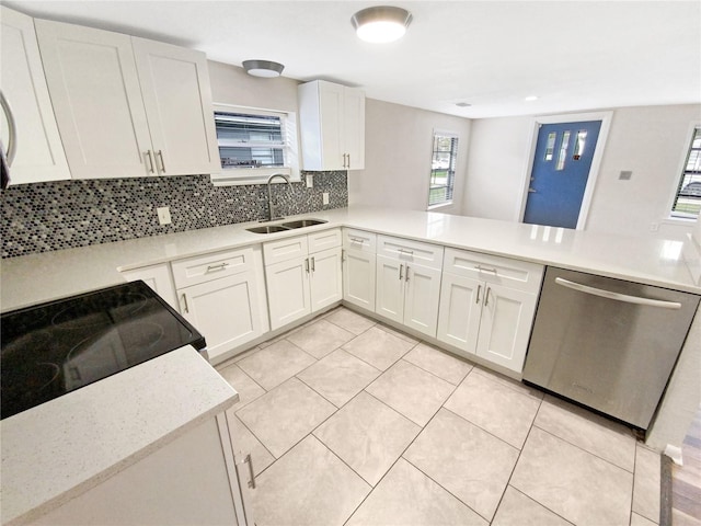 kitchen with white cabinetry, tasteful backsplash, sink, and dishwasher