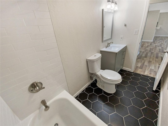 bathroom featuring toilet, vanity, and tile flooring