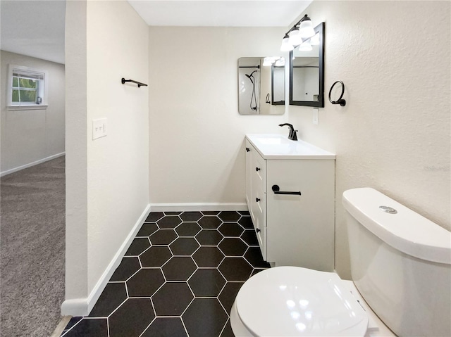 bathroom featuring toilet, tile floors, and vanity with extensive cabinet space