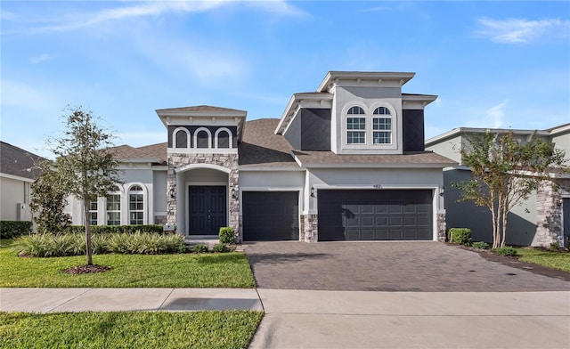 view of front of home featuring a front lawn and a garage