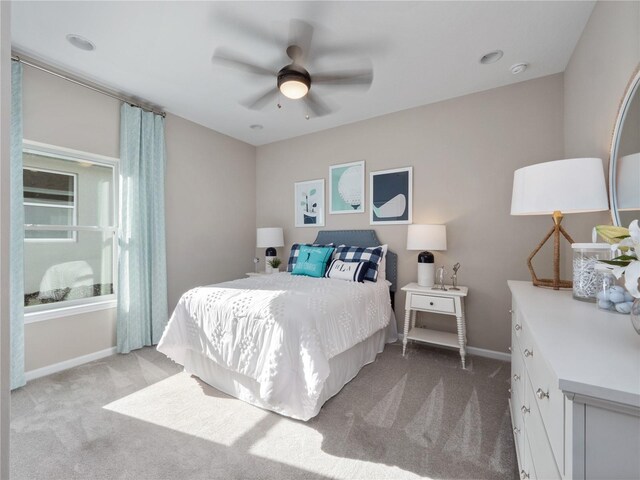 bedroom with light colored carpet and ceiling fan