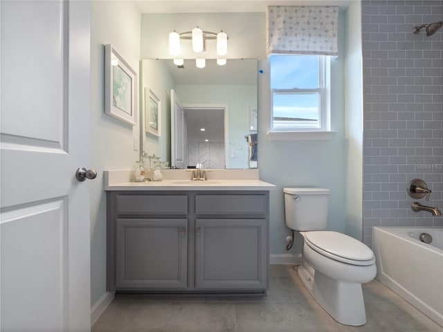 full bathroom with tiled shower / bath, toilet, tile flooring, and vanity