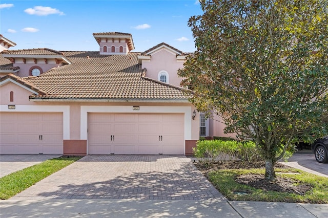 mediterranean / spanish-style home with a garage