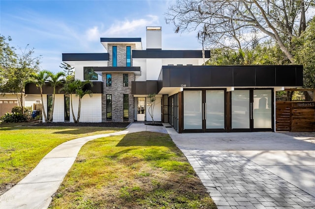 contemporary home featuring a front lawn