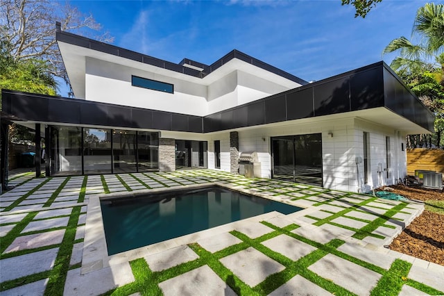 view of swimming pool with central AC unit and a patio area