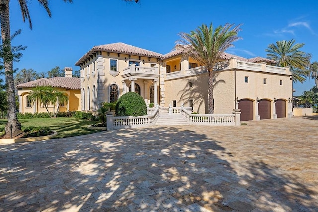 mediterranean / spanish-style house with a balcony and a garage