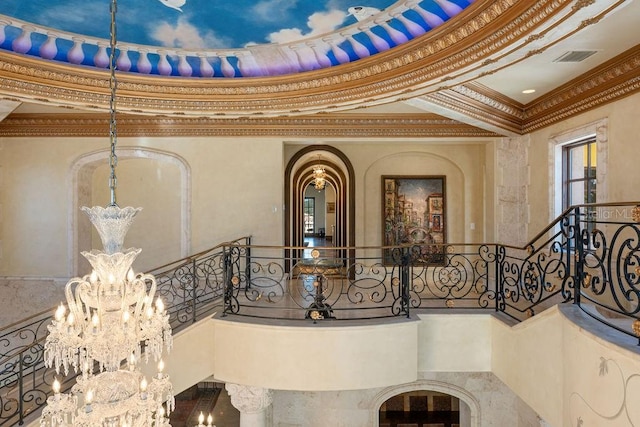 details featuring an inviting chandelier and crown molding